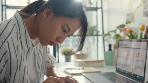Young Woman Working at Laptop in Office