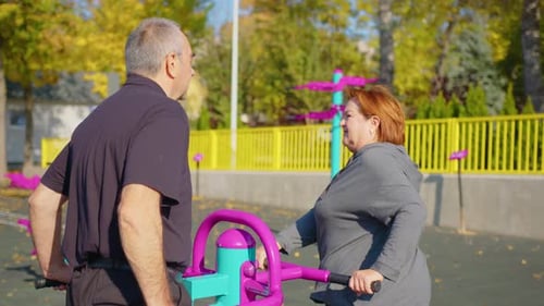 Active Elderly Couple Exercising Outdoors in a Park or Garden