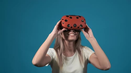 Woman Experiencing Virtual Reality and Taking Off Headset