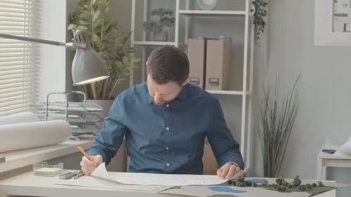 Landscape Architect Drawing Plan in Office