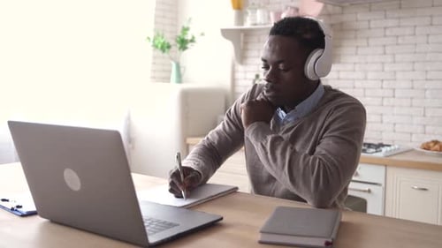 Black Male Student Talking Video Conference Calling at Home Office