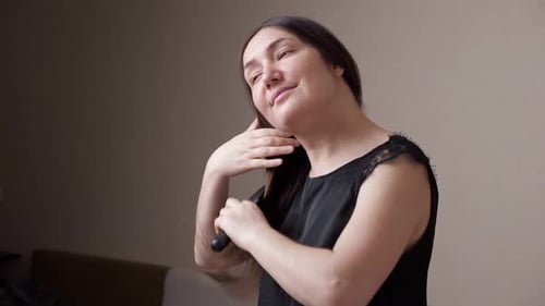 Woman Brushing Long Brown Hair Indoors