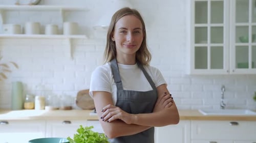 Confident Woman Smiling in Bright Kitchen