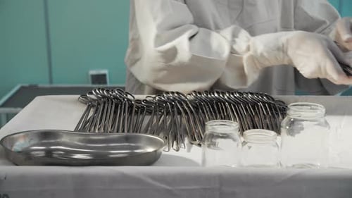 Gloved Hands Preparing Surgical Tools in Hospital Setting