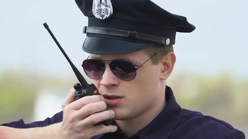 Police Officer Communicating with a Walkie Talkie