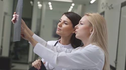 Doctor Looking at CT Scan of Patient's Brain
