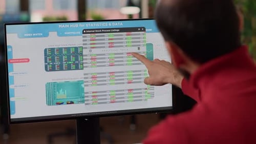 Business Investor Analyzing Stock Market Trend on Monitor