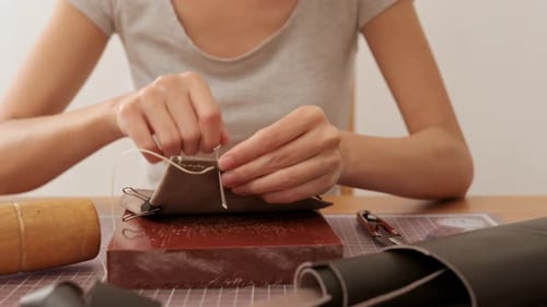 Woman Hand Sewing Leather in Studio