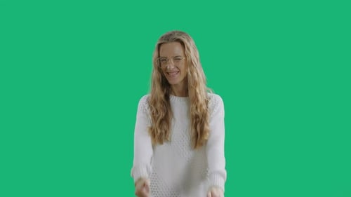 Smiling Woman Is Showing Thumbs Up Isolated on a Green Screen Chroma Key Background