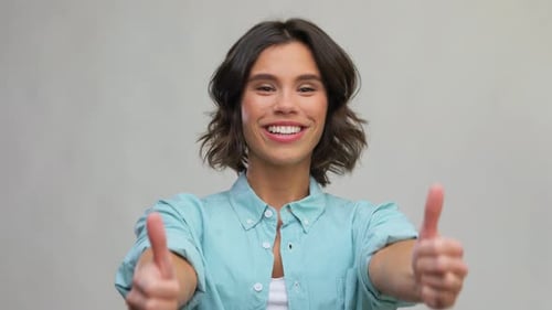 Woman Smiling and Giving Double Thumbs Up