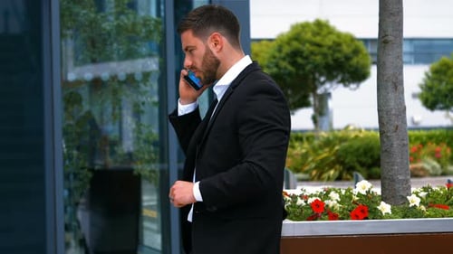 Man In Suit Talking on Phone Outside Office