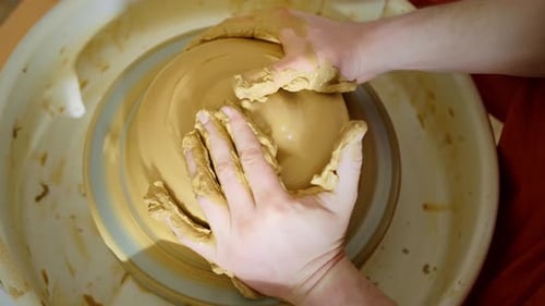 Hands Shaping Clay on Pottery Wheel Close-Up