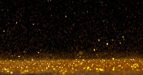Goldpulver fällt auf schwarzen Hintergrund, Zeitlupe 4K