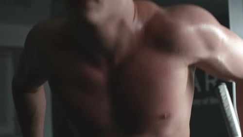 Muscular Man Doing Dips in Gym