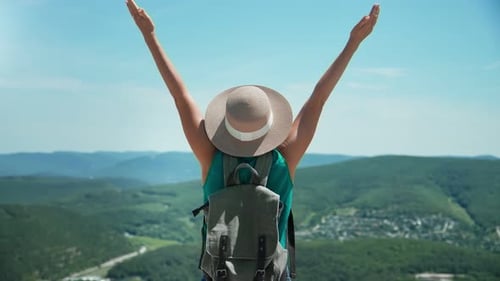 Tourist Woman Raising Hand Standing on Top of Mountain