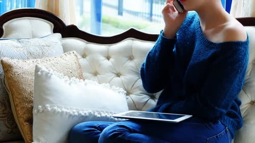 Woman Relaxing on Couch Talking on Phone