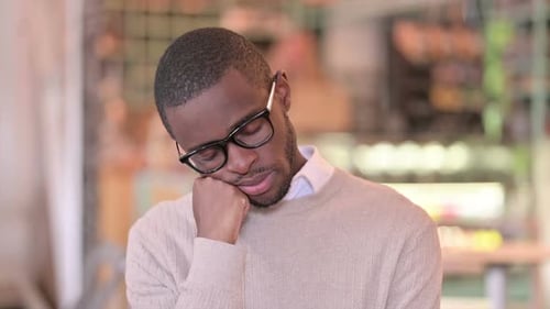 Portrait of Tired Young African Man Taking Nap