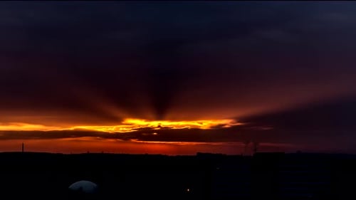 Dramatic Sunset Time Lapse Over Cityscape Silhouette