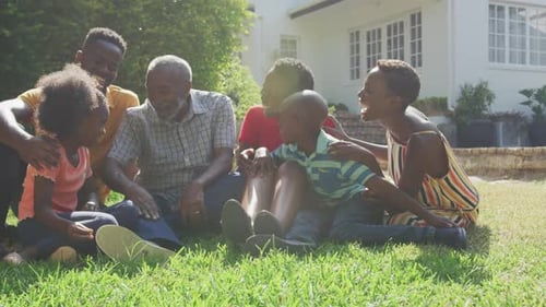 Family Laughing Together in Suburban Yard on Sunny Day