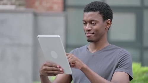 Portrait of Ambitious Young Young African Man Using Digital Tablet