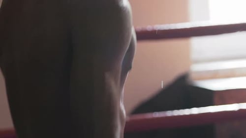 Hardy Multiethnic Muay Thai Fighter Warming up In Ring Motivating Himself to Win
