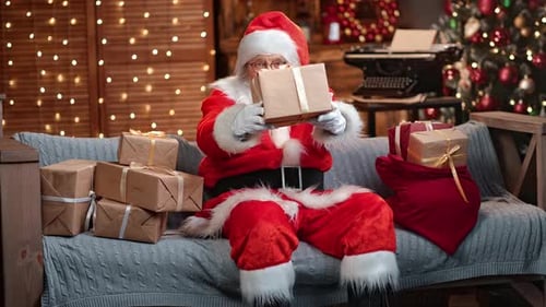 Funny Aged Man in Santa Claus Costume Give Festive Present at Christmas