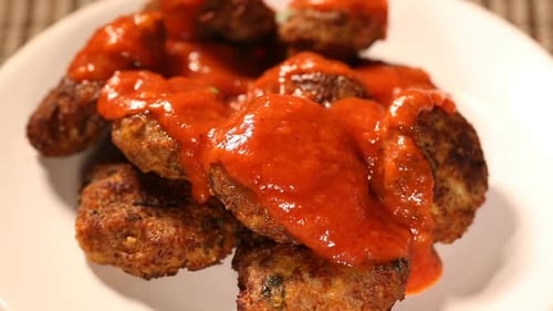 Appetizing Meatballs Topped With Delicious Sauce and Herbs