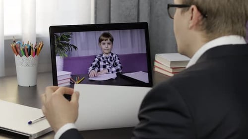 Boy in Suit Talks to Child on Video Call