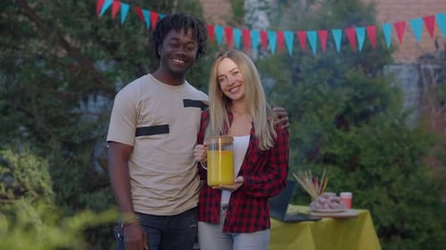 Couple Smiling at Backyard Barbecue Party