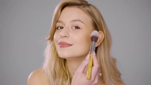Pretty Woman Doing Makeup in Studio