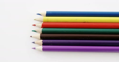 Close-up of colored pencils arranged in a row