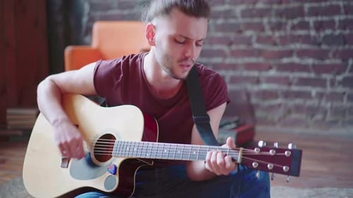 Handsome Young Man Playing Acoustic Guitar Sitting Floor Living Loft Room