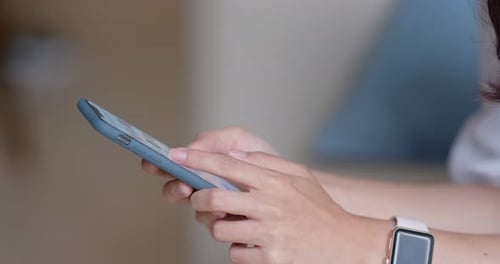 Close up of woman use of mobile phone at home