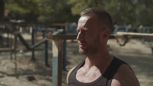 Man Lifting Weights at Outdoor Urban Gym