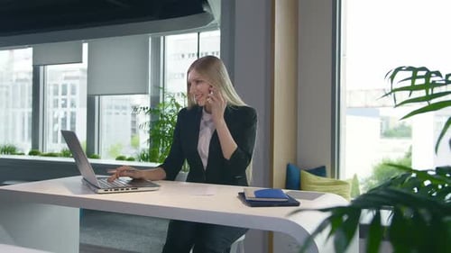 Woman Working in Modern Office Talking on Phone