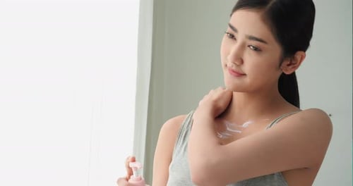 Beautiful woman apply lotion cream