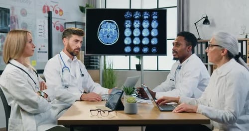 Doctors Analyzing Brain Scans in Medical Office