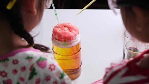 Kids Conducting Colorful Science Experiment with Solutions