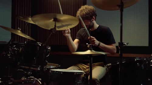 Musician Hitting Percussion Instrument Indoor. Drummer Playing on Drum Kit