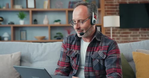 Mature Man Working at Home on Laptop