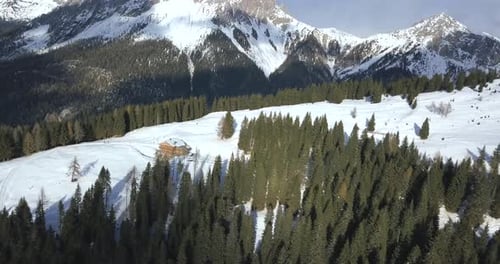 Aerial View of Cabin in Snowy Mountain Landscape