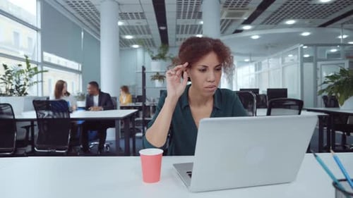 African American Businesswoman Working on Laptop in Coworking Space