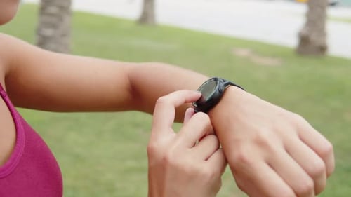 Woman Using Smartwatch for Fitness Tracking Outdoors