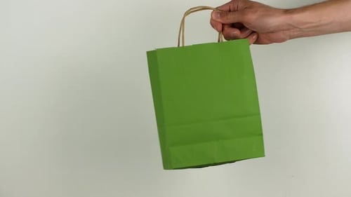 Passing a Birthday Gift in a Green Bag