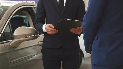 Men Shake Hands at the Dealership
