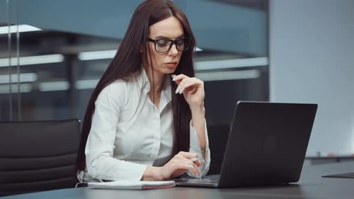 Businesswoman Financial Analyst Using Laptop in Office