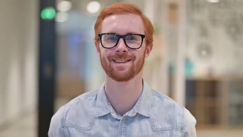 Smiling Young Redhead Man Looking at Camera