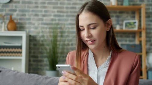 Woman Using Smartphone in Cozy Living Room