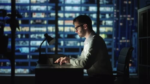 Portrait of Thoughtful Successful Businessman Working on Laptop Computer in His Big City Office at