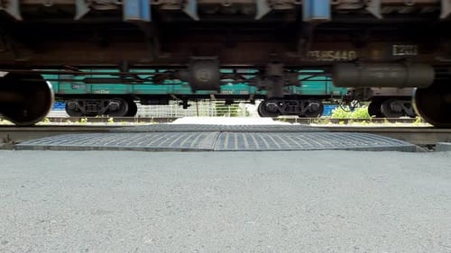 Wheels Freight and Passenger Trains Driving on Railway Rails View From Asphalt